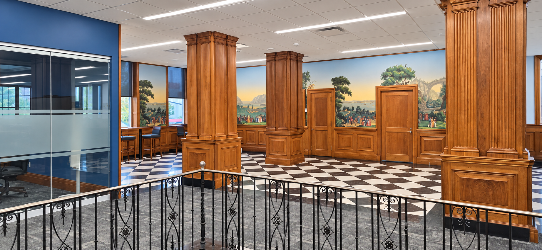 Historic mural, wood columns, and restored interior details at First Financial Bank