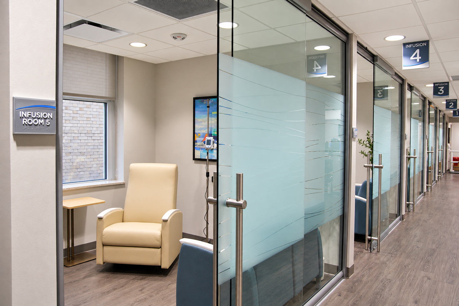 Glass-front treatment room and patient recliner at Primary Health Infusion Center